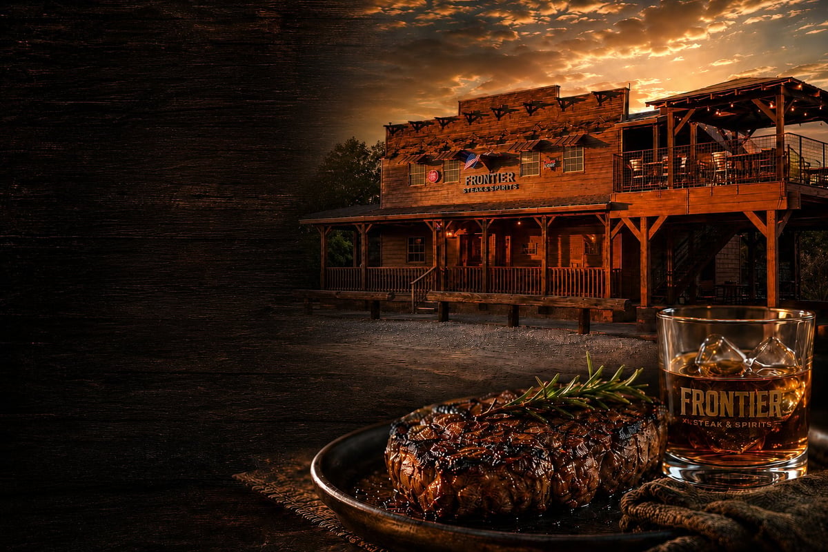Grilled steak on a plate with whiskey glass in front of an Old West saloon building at sunset
